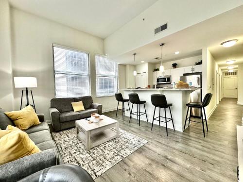 a living room with a couch and a table at Amazing New City View Mins To IU Health & Lucas Oil Stadium in Indianapolis