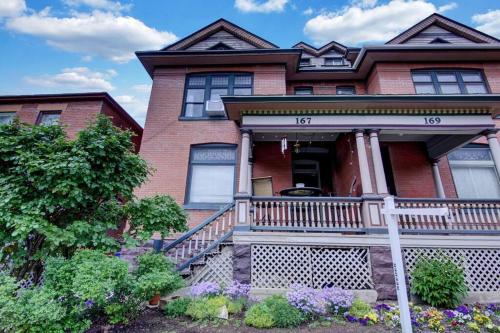 a large brick house with a porch and a balcony at B Street C in Salt Lake City
