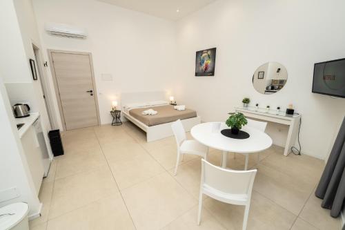 a living room with a table and a couch at Valguarnera Studio Apartments in Palermo