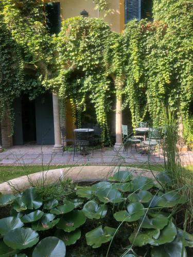 a patio with a table and chairs and plants at Palazzo Sismonda in Corneliano d'Alba