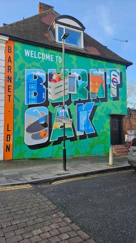 a building with a mural on the side of it at Cosy 2 bedroom flat in Edgware