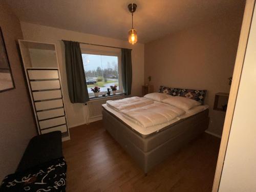 a bedroom with a bed and a window at Nissafors in Nissafors