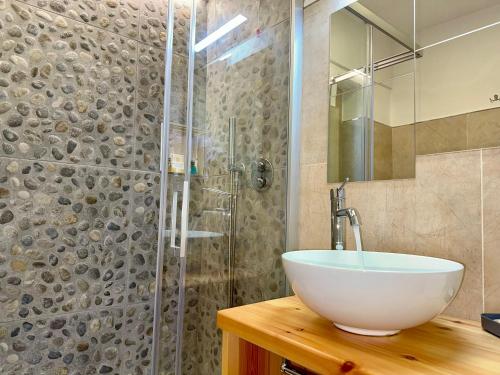 a bathroom with a sink and a glass shower at Hotel Lo Sciatore in San Massimo