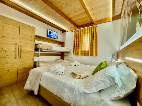 a bedroom with a bed with a book on it at Hotel Lo Sciatore in San Massimo