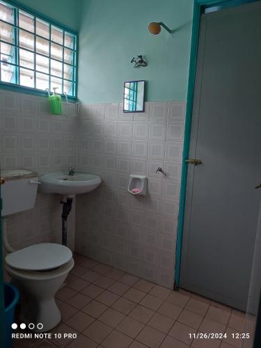a bathroom with a toilet and a sink at Homestay Dasuqi #Musl!m only in Seremban