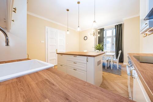 a kitchen with a large white tub and wooden floors at Casa Linda Zagreb - FREE PARKING in Zagreb