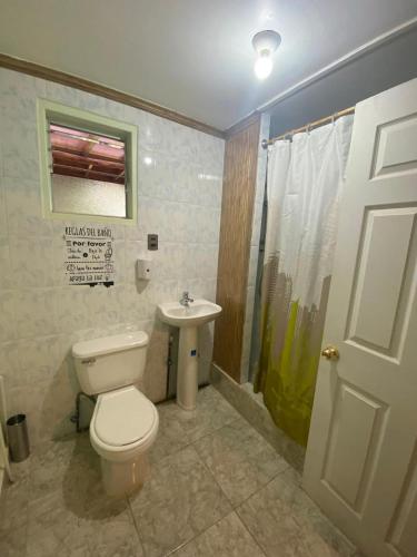 a bathroom with a toilet and a sink at Refugio Don Natu in San Pedro de Atacama