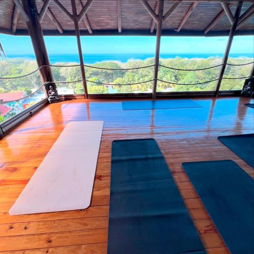 a yoga room with a view of the ocean at Horizon Hotel & Yoga Center in Santa Teresa Beach