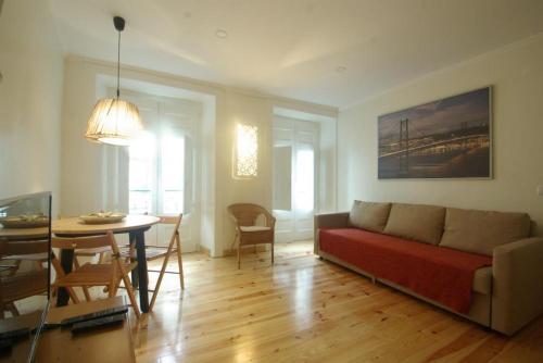 a living room with a couch and a table at My Mouraria Suites in Lisbon