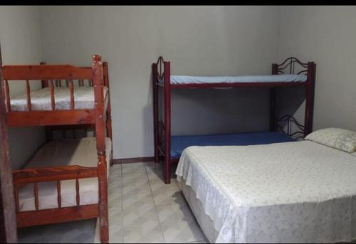 a room with two bunk beds and a bed at Nosso cantinho in Saquarema