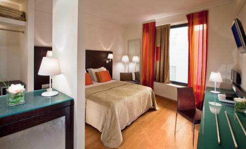a hotel room with a bed and a glass table at O&B Athens Boutique Hotel in Athens