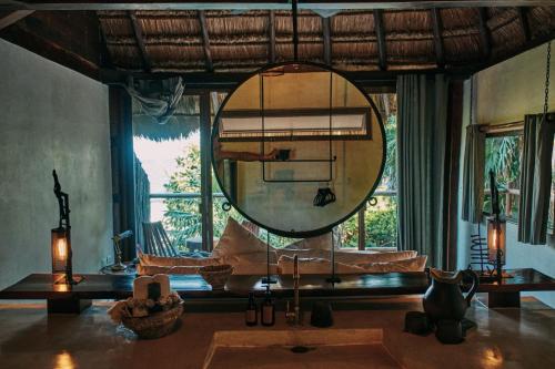 a bathroom with a large mirror in a room at Libelula Tulum Beachfront Hotel in Tulum