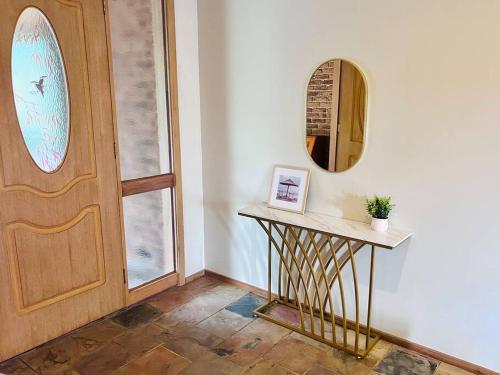 a room with a door and a table and a mirror at Peaceful home in forest in Wonga Park