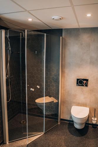 a bathroom with a shower and a toilet at Ringstad Resort in Bø