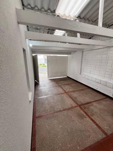 an empty hallway of a building with a ceiling at travelers house 5 minutes close to the airport in Bogotá