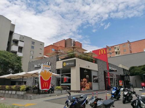 a mcdonalds restaurant with motorcycles parked outside of it at travelers house 5 minutes close to the airport in Bogotá