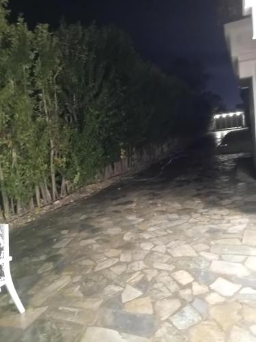 a car driving down a road at night at Meteora Grande luxury suite & spa villa in Kalabaka