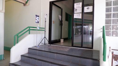 an entrance to a building with a glass door at ธรรศิกา อพาร์ทเม้นท์ in Kanchanaburi City