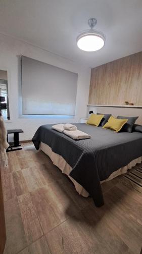 a bedroom with a large bed with yellow pillows at Aldea Mate Amargo in Potrero de Garay