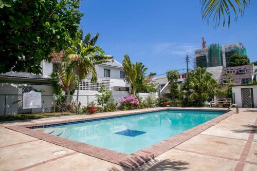 a swimming pool in front of a house at Carter's Nest Villa - New Kingston - FIWI in Kingston