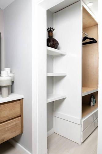 a white closet with white shelves in a room at Carter's Nest Villa - New Kingston - FIWI in Kingston