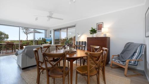 a kitchen and dining room with a table and chairs at Thistledoo in Callala Beach