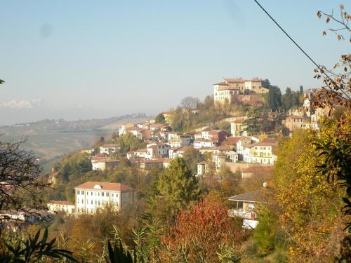 a town on top of a hill with houses at La Terrazza sul Monferrato in Ozzano Monferrato