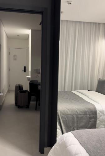 une chambre avec un lit, un bureau et un miroir dans l'établissement Porto Alto Resort, à Porto de Galinhas