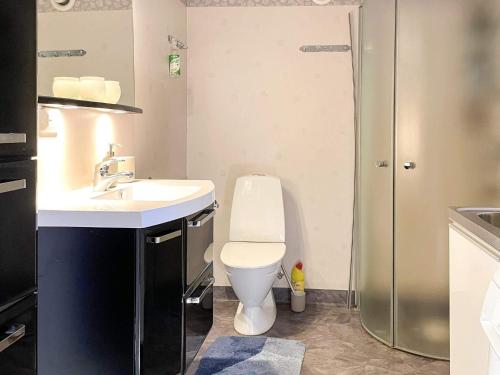 a bathroom with a toilet and a sink and a shower at 4 star holiday home in UDDEVALLA in Uddevalla