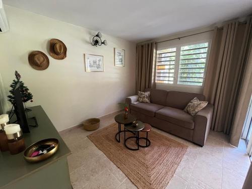 a living room with a couch and a table at Manbana 322 in Grand-Bourg