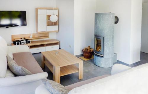 a living room with a fireplace and a couch at Ferienwohnung Karlshagen in Ostseebad Karlshagen