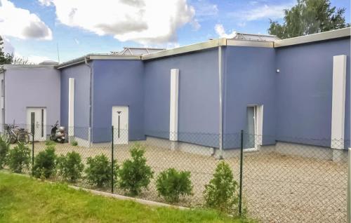a large blue building with a fence around it at Ferienhaus Neubrandenburg in Neubrandenburg