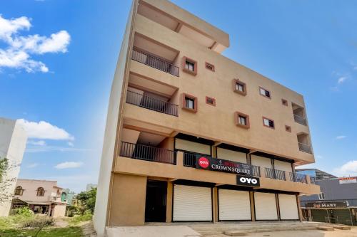 an apartment building with a q axis sign on it at Hotel O Crown Square in Bhopal
