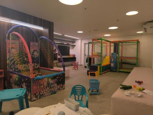 a childrens play room with play equipment and tables at Salinas Exclusive Resort in Salinópolis
