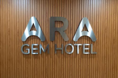 a sign for a german hotel on a wooden wall at ARA Gem Hotel in Ho Chi Minh City