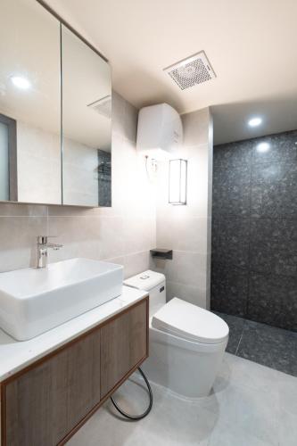 a bathroom with a sink and a toilet and a shower at ARA Gem Hotel in Ho Chi Minh City