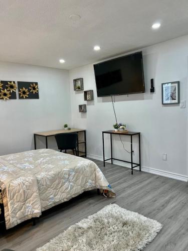 a bedroom with a bed and a flat screen tv at K1 Private Bathroom Queen Bed Room in Mississauga