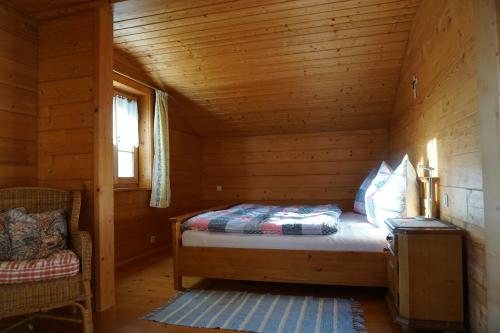 a bedroom with a bed in a wooden cabin at Ferienhaus Höllwart in Pfarrwerfen