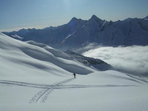 a person is skiing down a snow covered mountain at Pension Bergkristall in Tux