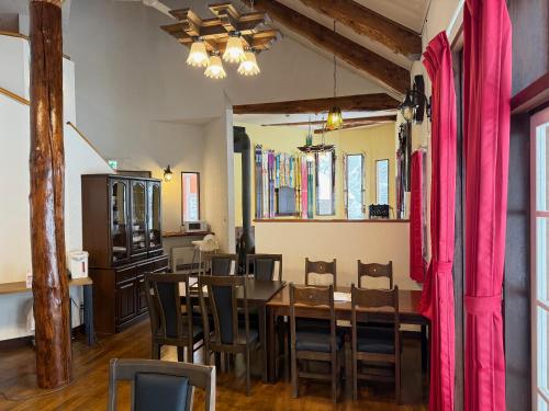 a dining room with a table and chairs at Hotel Junior Mint Hakuba in Hakuba