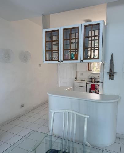 a white kitchen with a counter and a counter top at Sunset Cove - Vacation In Paradise! in Nassau