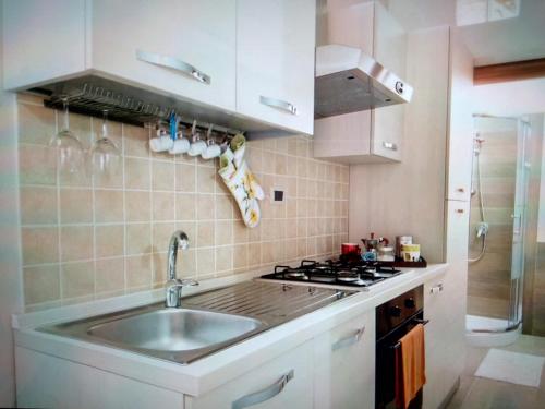 a kitchen with a sink and a stove at Casa Antonella in Syracuse