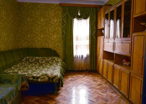 a bedroom with a bed and a window at Nova Lux Apartments in Tbilisi City