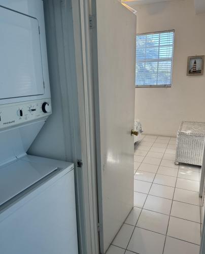 a kitchen with a washer and dryer in a room at Sunset Cove - Vacation In Paradise! in Nassau