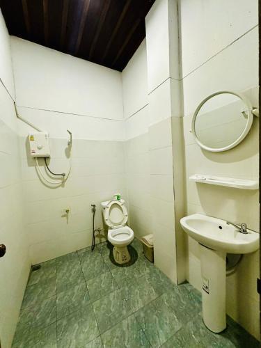 a bathroom with a toilet and a sink at Luangprabang Residence Boutique Hotel in Luang Prabang