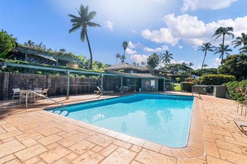 a swimming pool with a patio and a house at International Colony Club 37 · ICC 37 Remodeled Hawaiian Cottage in Kaanapali
