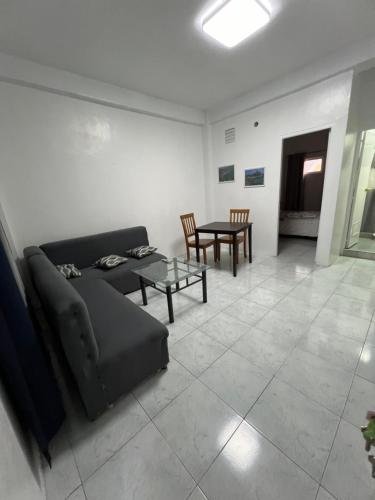 a living room with a couch and a table at Bianco 304 VAJai Apartments in Angeles