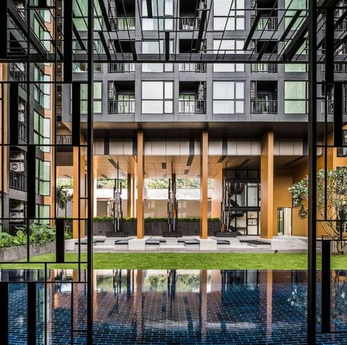 a building with a reflection of a pool in front of it at The Base Hight 一卧公寓 in Phuket Town