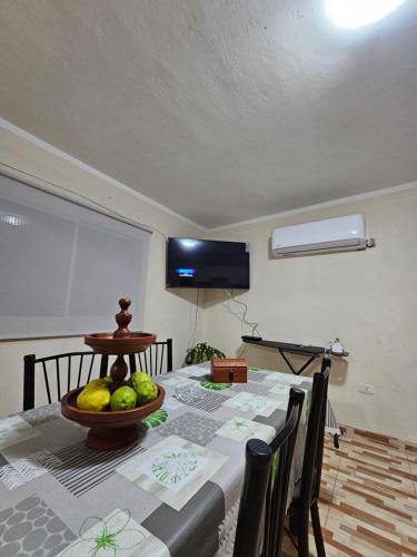 a dining room table with a bowl of fruit on it at Residencia completa in Tinogasta