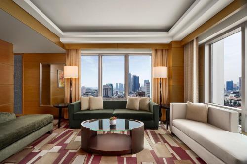 a living room with a couch and a table at JW Marriott Hotel and Suites Saigon in Ho Chi Minh City